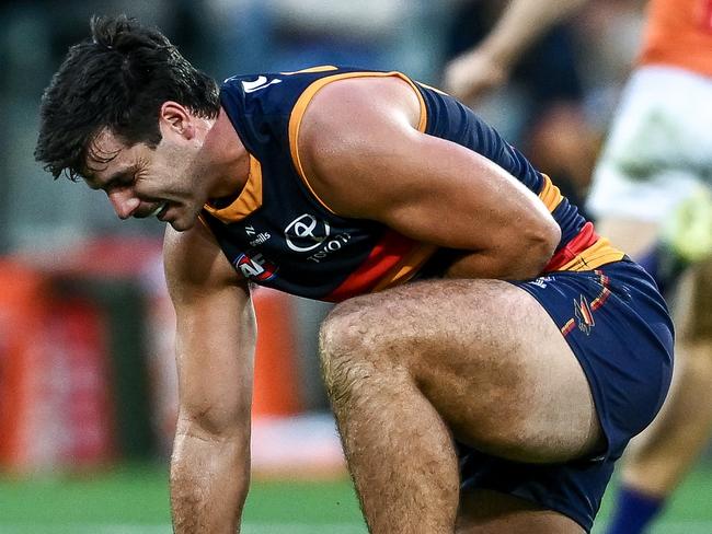 ADELAIDE, AUSTRALIA - APRIL 19: Darcy Fogarty of the Crows in pain after a tackle from Harry Himmelberg of the Giants during the round six AFL match between Adelaide Crows and GWS Giants at Adelaide Oval, on April 19, 2025, in Adelaide, Australia. (Photo by Mark Brake/Getty Images)