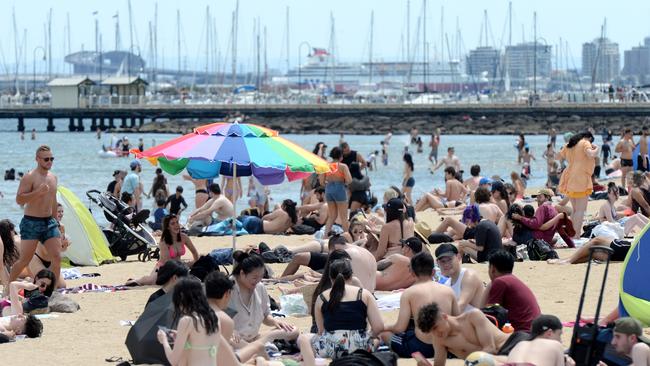 Crowds soak up the sun on St Kilda beach. Picture: NCA NewsWire / Andrew Henshaw