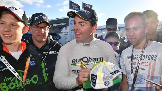 Craig Lowndes signs autographs at Mt Panorama on Saturday. Picture: AAP