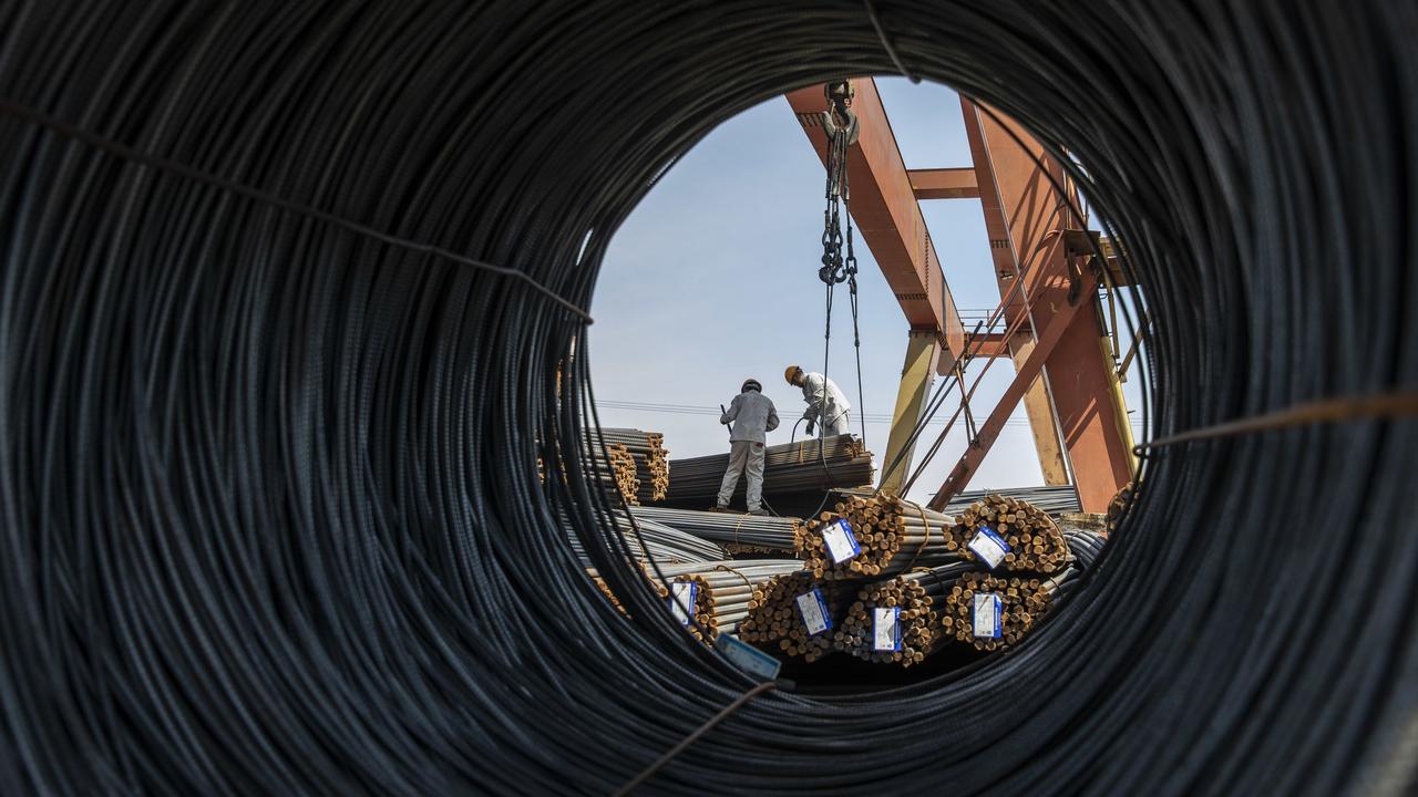 Workers at a metal stock yard in Shanghai, China. China’s iron ore imports are crucial to the Aussie market. Photographer: Qilai Shen/Bloomberg