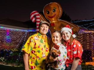 The Christmas lights display of the Ewing family of Iris Court, pictured are Chloe holding Leo and Caitlin with dad Glen Ewing, Thursday, December 8, 2022. Picture: Kevin Farmer