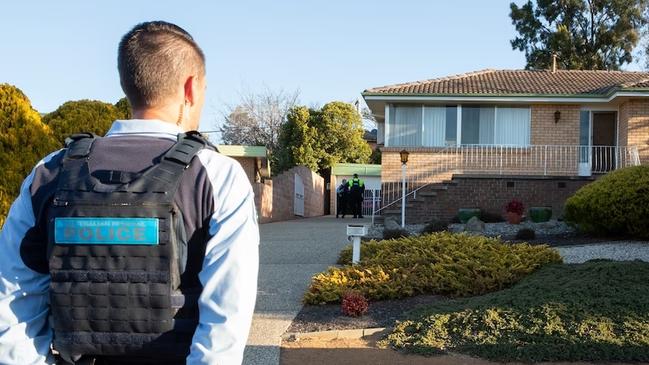 A police officer outside the murder scene at the home of Donald and Jean Morley in the Canberra suburb of Fisher. Picture: ACT Policing