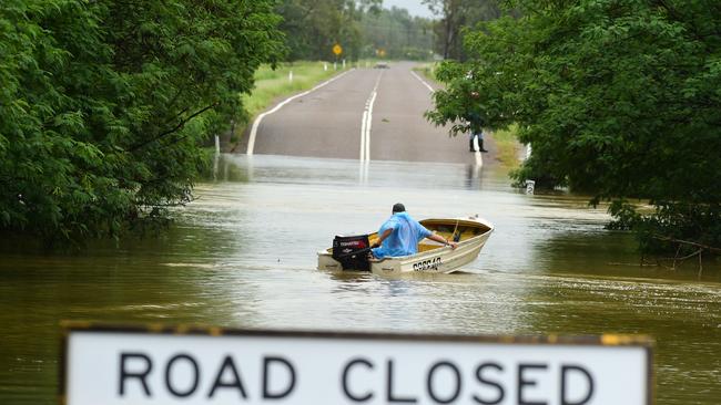 Wet weather in Townsville. Poultry farmer Jeff Ironside heads back for more after bringing people across the Bohle River, cut by flood water at Allambie Lane. Picture: Evan Morgan