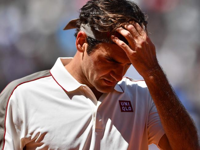 (FILES) This file photo taken on June 07, 2019 shows Switzerland's Roger Federer during his men's singles semi-final match of The Roland Garros 2019 French Open tennis tournament in Paris. - Men's Grand Slam singles record-holder Roger Federer said on June 10, 2020 he would be sidelined until 2021 after undergoing keyhole surgery on his right knee. (Photo by Martin BUREAU / AFP)