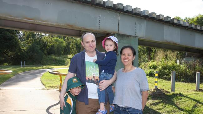 Algester residents Mallory Wuthrich and Mei-Ya Lin with their children Joshua, 5, and Madeleine, 2 at Col Bennett Park under the existing train track. Photo: Kristy Muir