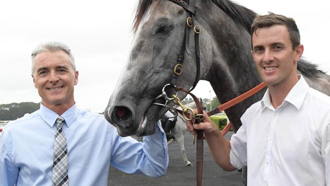 Trainers Robert (left) and Luke Price saddle up Devilish Dude at Moruya. Picture: AAP Image