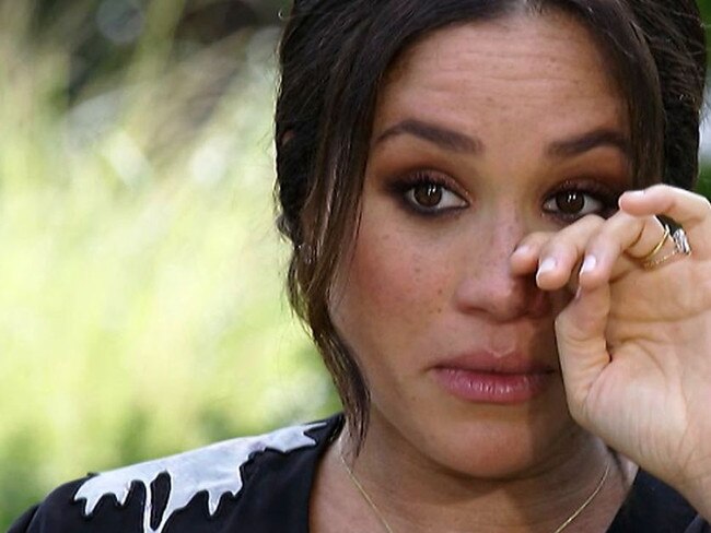 An emotional Meghan wipes a tear away during the Oprah interview.