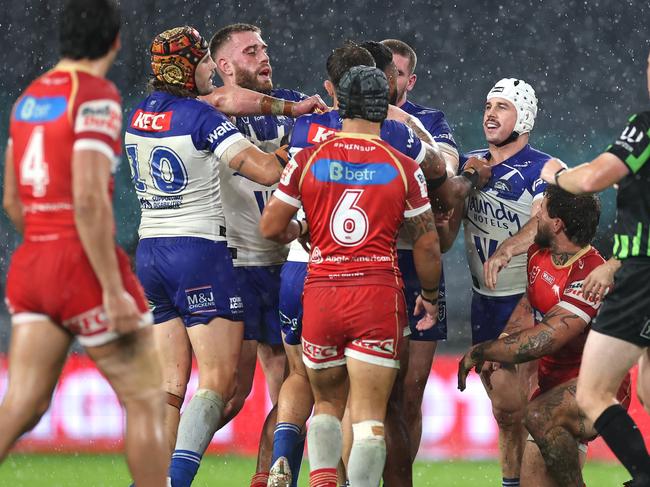 SYDNEY, AUSTRALIA - MAY 22: Samuel Hughes and Reed Mahoney of the Bulldogs scuffles with Francis Molo of the Dolphins during the round 12 NRL match between Canterbury Bulldogs and Dolphins at Accor Stadium on May 22, 2025, in Sydney, Australia. (Photo by Cameron Spencer/Getty Images)