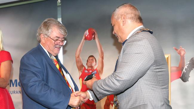 Former editor Bob Gordon pictured getting the keys to the city from Mayor Tom Tate at a presentation Function held at the Metricon Stadium. Pic Mike Batterham