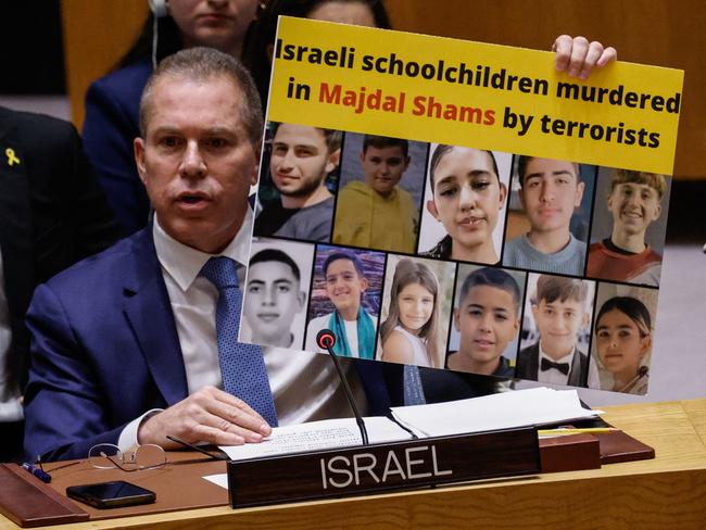 Israel's Ambassador to the United Nations Gilad Erdan holds up a poster of murdered schoolchildren as he speaks during a UN Security Council meeting on Gaza and the situation in Middle East at UN headquarters in New York City. Picture: AFP