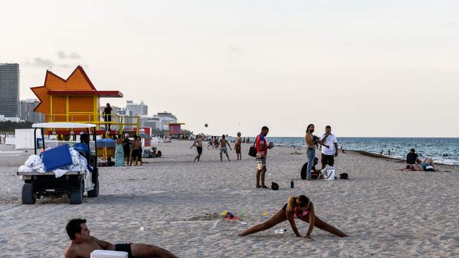 People enjoy the beach in Miami Beach, Florida, which reported a state record of 9,585 new coronavirus cases on Saturday Picture: AFP