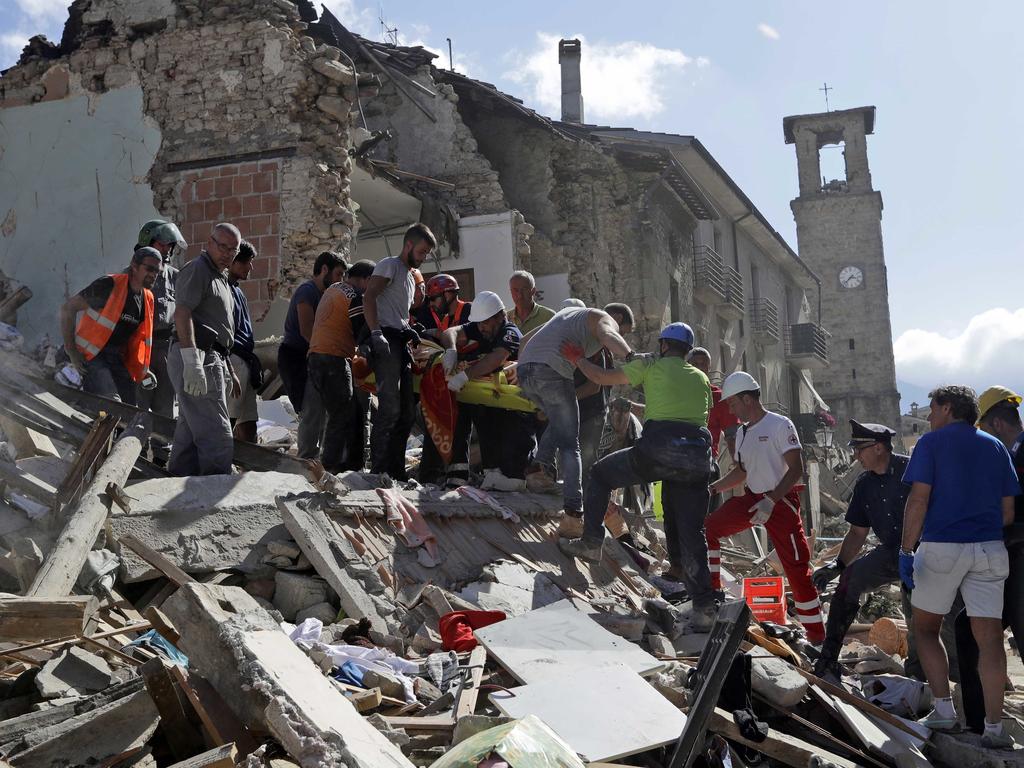 Rescuers carry a stretcher following an earthquake in Amatrice, central Italy, on August 24, 2016. Picture: AP