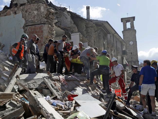 Rescuers carry a stretcher following an earthquake in Amatrice, central Italy, on August 24, 2016. Picture: AP