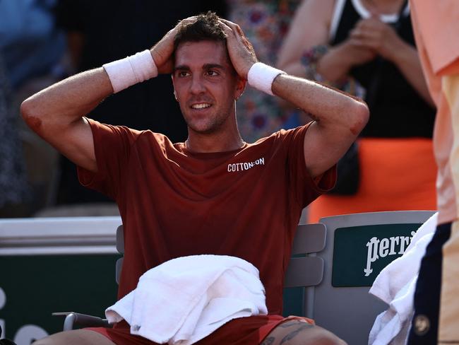 Australia's Thanasi Kokkinakis reacts after his victory over Switzerland's Stan Wawrinka during their men's singles match on day four of the Roland-Garros Open tennis tournament at the Court Simonne-Mathieu in Paris on May 31, 2023. (Photo by Anne-Christine POUJOULAT / AFP)