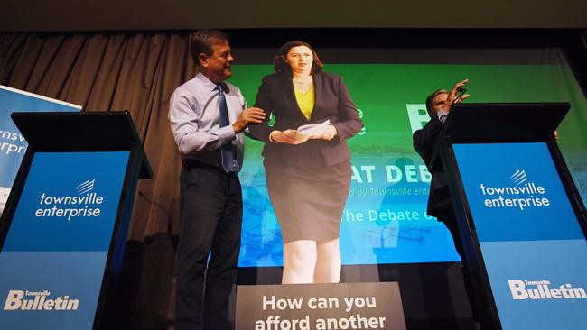 Queensland Opposition Leader Tim Nicholls carries a cardboard cutout of Queensland Premier Annastacia Palaszczuk. Picture: AAP.