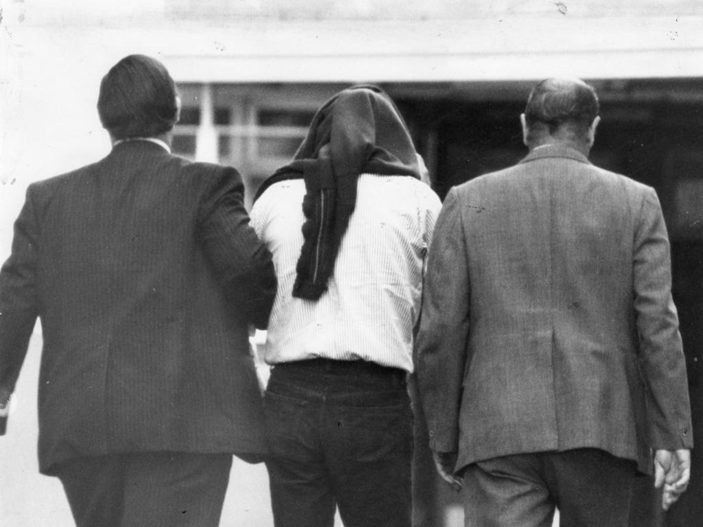 James William Miller is led into the Adelaide Magistrates Court on May 24, 1979.