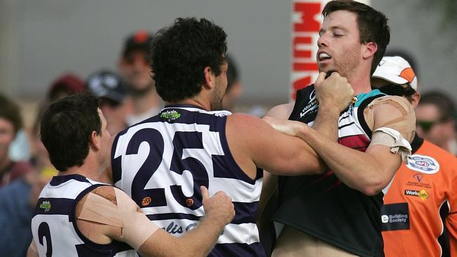 Former Lavington coach James Saker tangles with Yarrawonga’s Brendan Fevola in the Ovens and Murray league.