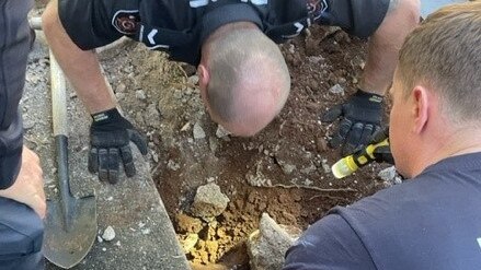 The curious pup somehow got herself stuck under a cavity in a concrete driveway on Monday.