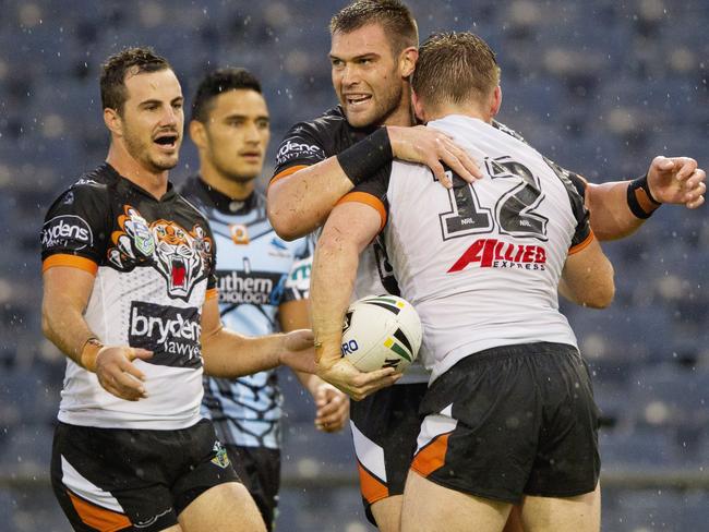 Newcomer Tim Grant hugs Chris Lawrence after a try during the Wests Tigers v Cronulla Sharks pre season trial game at Campbelltown Stadium. Photo: Jenny Evans