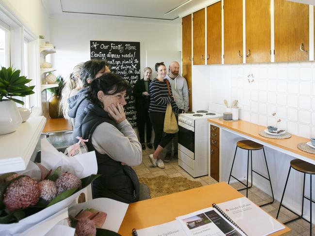 MANLY DAILY AAP Photo of the crowd in the kitchen at the 122 Parkes Rd Collaroy Plateau on Saturday the 11th May 2019.The old home held in same family since 1962 has had lots of interest with 140 groups inspecting it.Property did sell to young couple Brad Rowan & Elke Dupere Rowan.AAP IMAGE/ Tim Pascoe