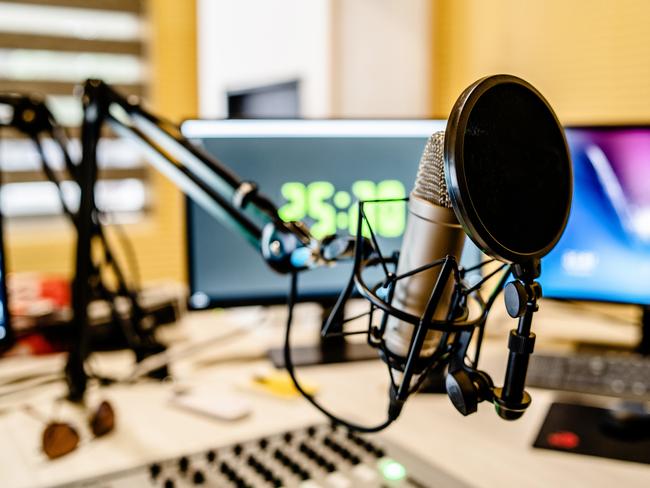 Microphone and mixer at the radio station studio broadcasting news. iStock