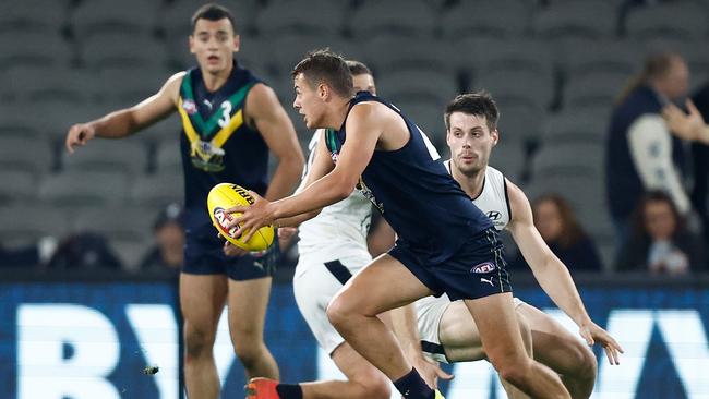 Cooper Simpson runs with the ball. Picture: Michael Willson/AFL Photos via Getty Images