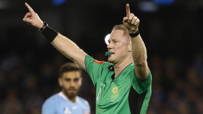 Referee Kurt Ams signals for the VAR during the Melbourne derby.