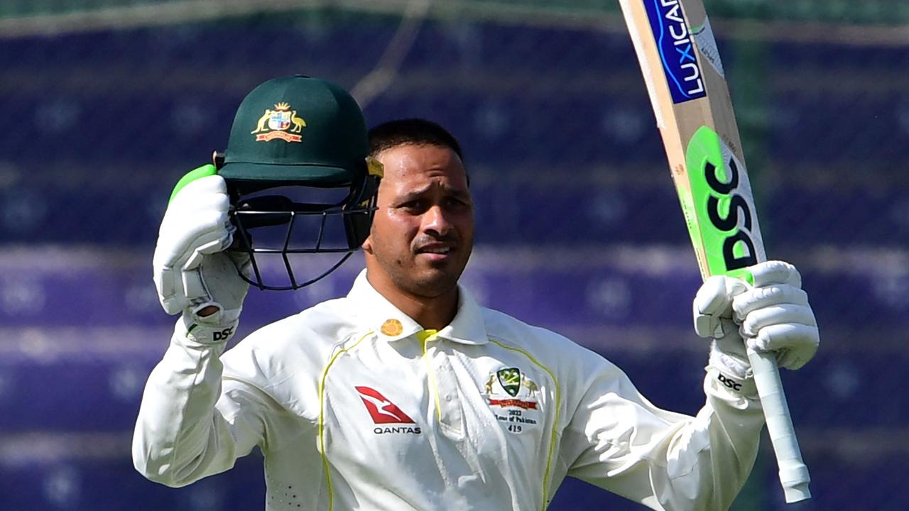 Australia's Usman Khawaja celebrates after scoring a century. Photo by ASIF HASSAN / AFP.