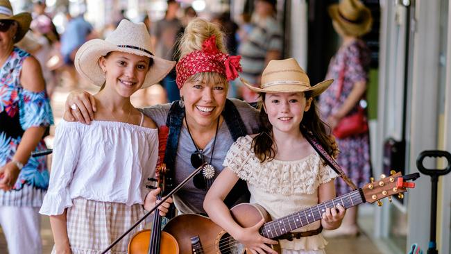 Sisters Tia (left) and Ellie Hannah, aged 11 and 9, with their mother Felicity Urquhart. The sisters have been busking on Peel Street as The Meadows during the Tamworth Country Music Festival. Picture: Antony Hands