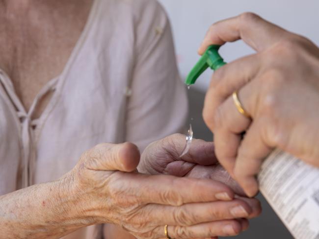 SYDNEY, AUSTRALIA - NewsWire Photos OCTOBER 11, 2020: A woman is seen receiving hand sanitiser at Bunnings Alexandria where itÃs sausage sizzle has resumed after COVID-19 restrictions. Picture: NCA NewsWire / Jenny Evans