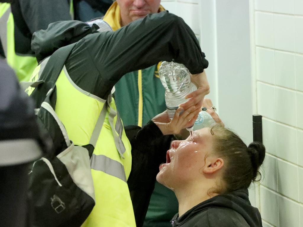 A woman being treated after being pepper sprayed by police. Picture: Damian Shaw