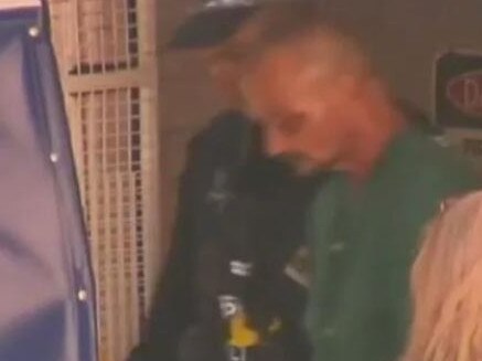 Ben Hoffman being led out of hospital to be taken to Darwin watch house. Picture: 7News