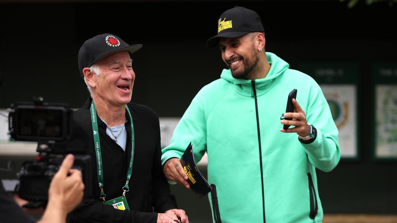 Kyrgios reacts with fellow commentator John McEnroe at All England Club. (Photo by Clive Brunskill/Getty Images)