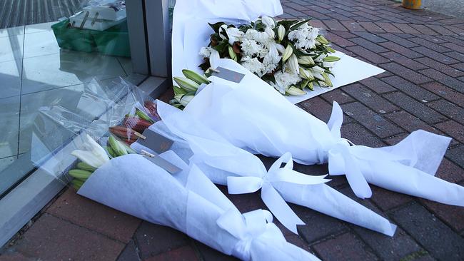 Flowers at the door of Fitness First the day after the shooting.