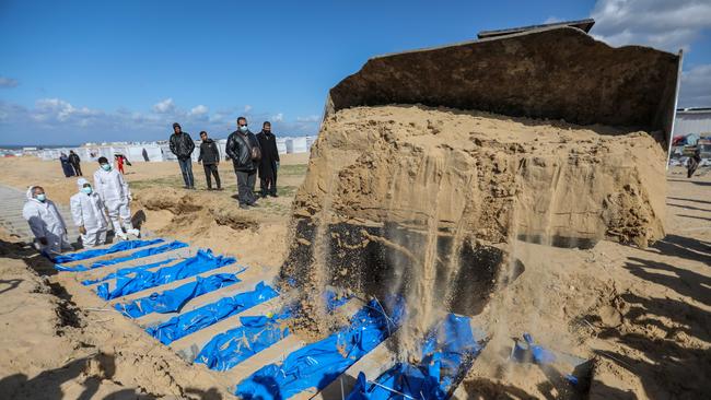 A mass grave containing the bodies of Palestinians killed during the war are buried. Picture: Getty Images