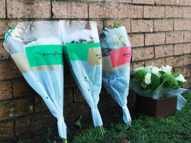 25/7/22: Flowers left at a fatal fire at a home in Hinchinbrook which has claimed the lives of three occupants thought to be from the same family. John Feder/The Daily Telegraph