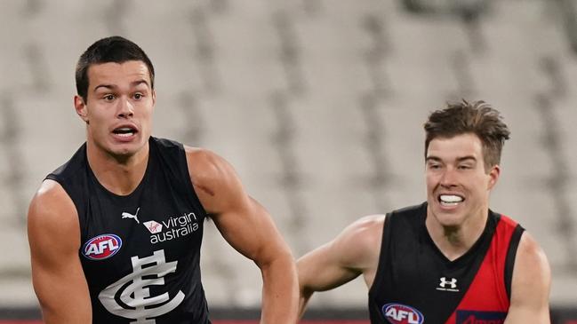 Zach Merrett pursues Jack Silvagni.