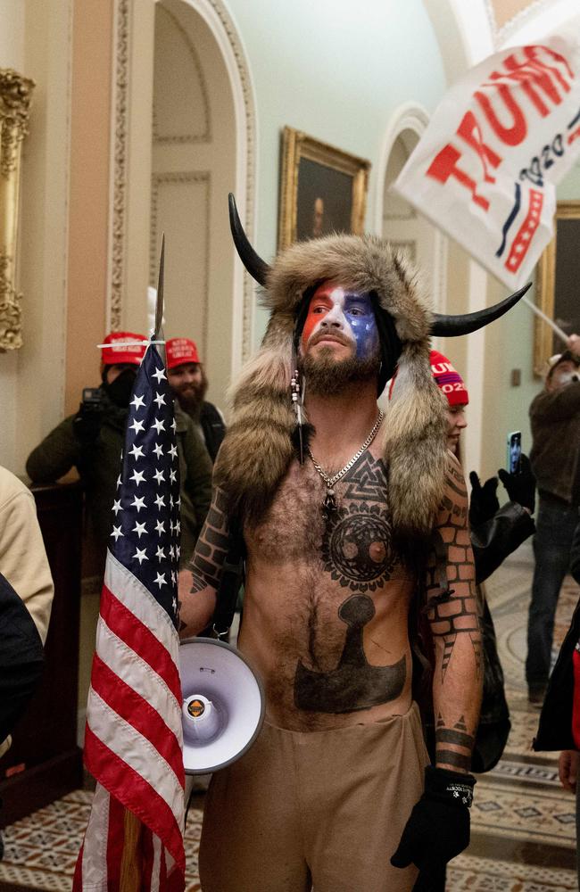 Member of the QAnon conspiracy group Jacob Anthony Chansley, aka QAnon Shaman (C), entered the US Capitol. Picture: AFP