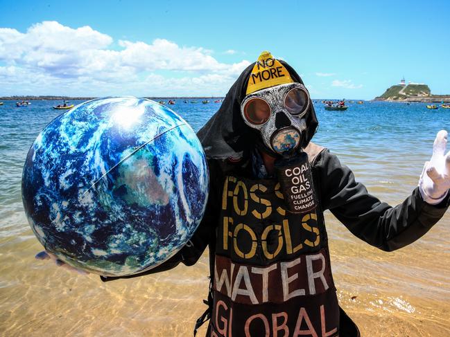 A protester in Newcastle harbour goes to extreme lengths to make their point. Picture: Roni Bintang/Getty Images)