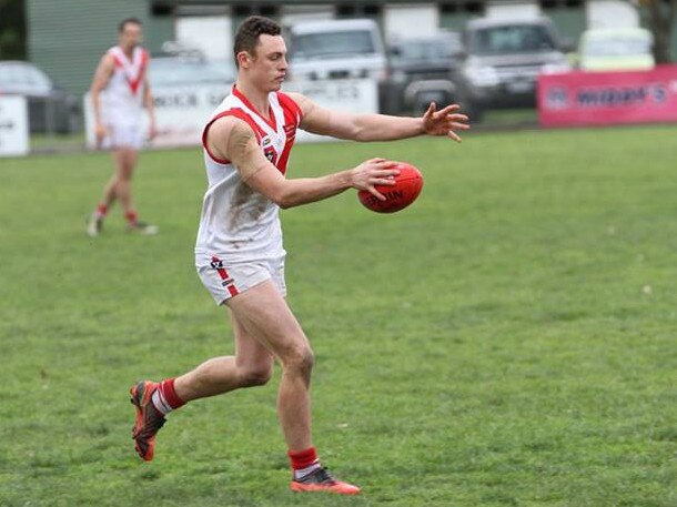 Olinda Ferny Creek's Nick Keegan takes a kick.