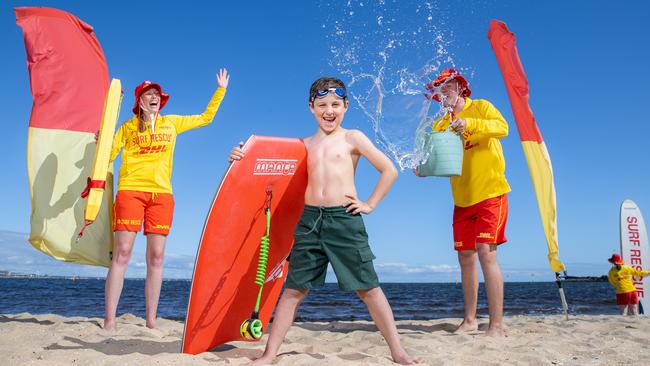 Ethan is ready for a safe summer overlooked by Surf Life Savers Jess and Jack. Picture: Jason Edwards