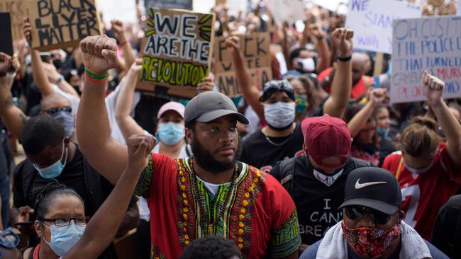 Thousands of members of the community raise their fists as they gather to mourn the death of George Floyd during a march across downtown Houston, Texas. Picture: AFP