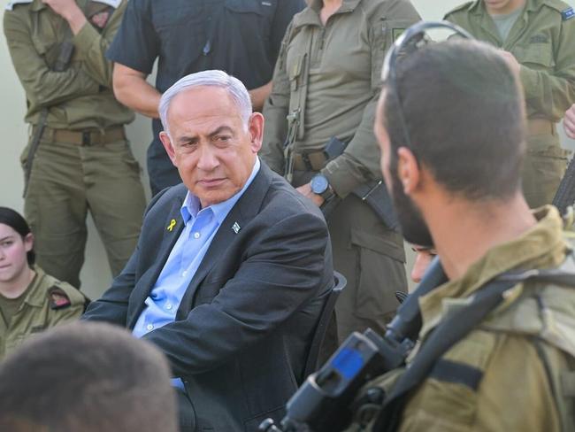 Prime Minister Benjamin Netanyahu, center, visits a Golani training base targeted by a deadly Hezbollah drone strike a day earlier, October 14, 2024. (Kobi Gideon/GPO)