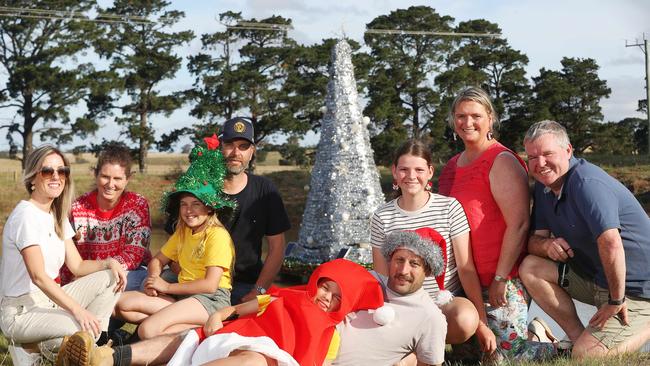 The van Dreven, Heagney and Butcher families with their floating Christmas tree in Sutherlands Creek. Picture: Alan Barber