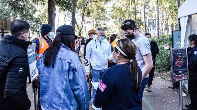 People wait to be vaccinated at Homebush Olympic Park in Sydney on Monday. Picture: Flavio Brancaleone