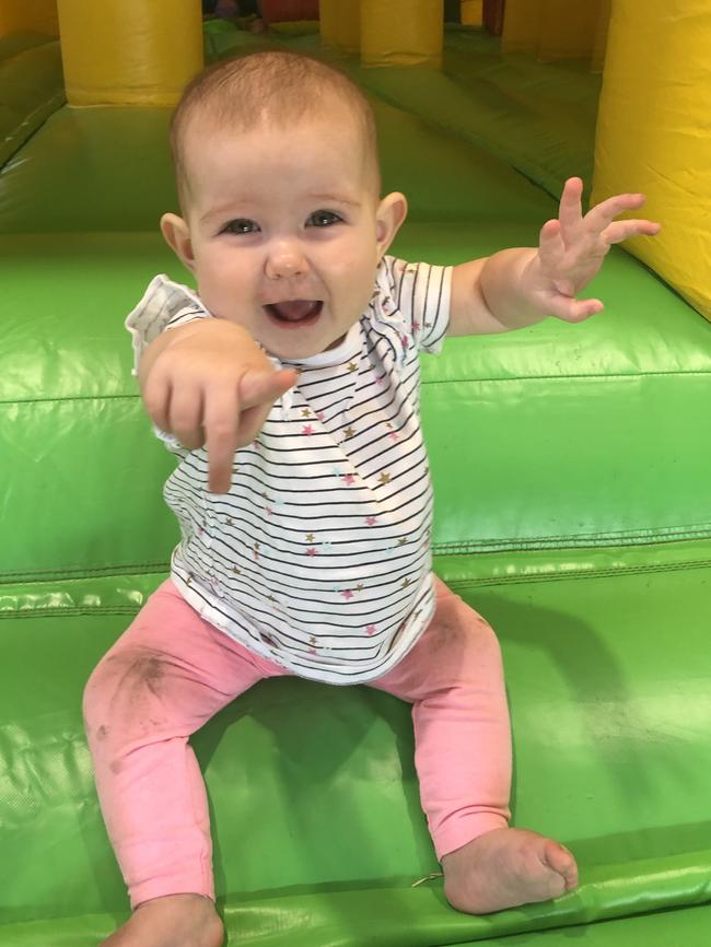 Olivia Sansom ... Jumping castle fun at 10 months. Picture: Catherine