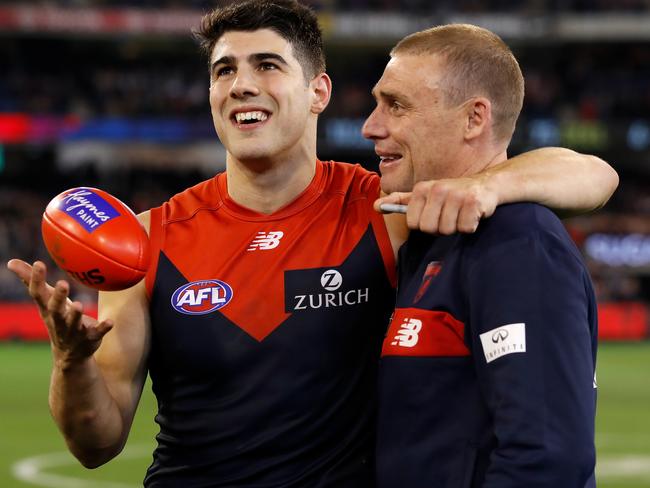 Christian Petracca of the Demons celebrates with coach Simon Goodwin.