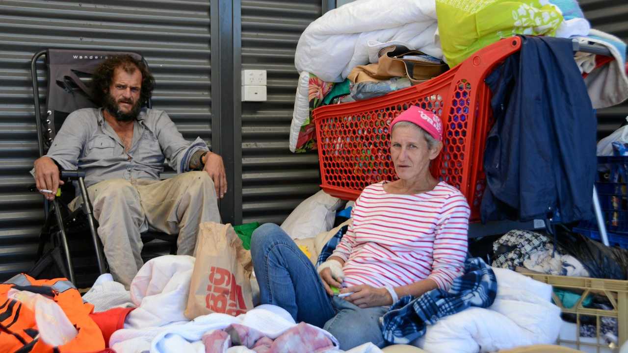 FORGOTTEN: Aaron Burke, 34, and partner Michelle Sharpe, 43, sit amidst everything they own in a makeshift shelter at Clewley Park off Water St. It has been the couple's home for two months. Picture: Tara Miko