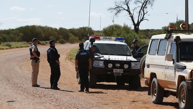 Police investigating one of the crime scenes in the APY Lands. Picture: Simon Cross