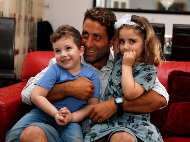 Noah (L) and Lahela al-Amine pose for a picture with their father Ali Zeid al-Amine (aka Ali Elamine) in their family home in Beirut, Lebanon April 8, 2016. REUTERS/Mohamed Azakir TPX IMAGES OF THE DAY - RTSE5QJ